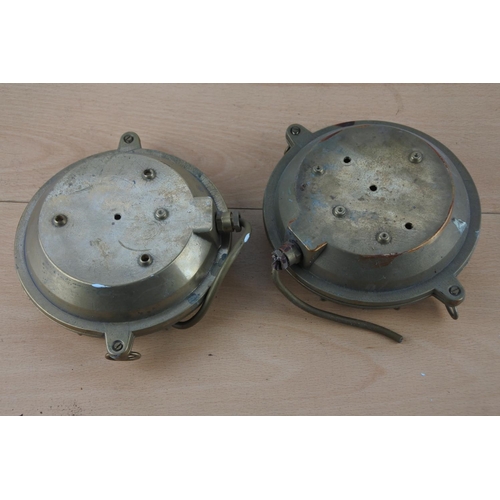 518 - Two vintage brass cased nautical lights, each measuring 15cm in diameter.