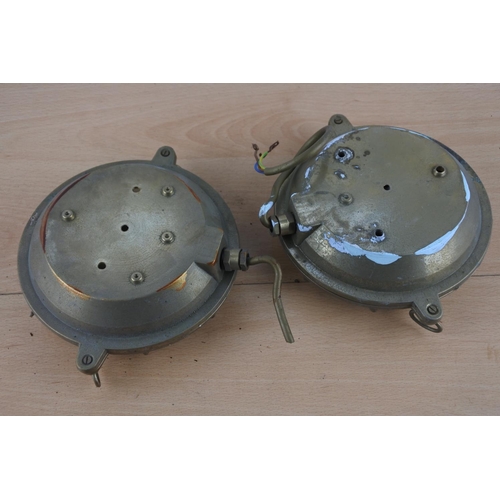 524 - Two vintage brass cased nautical lights, each measuring 15cm in diameter.