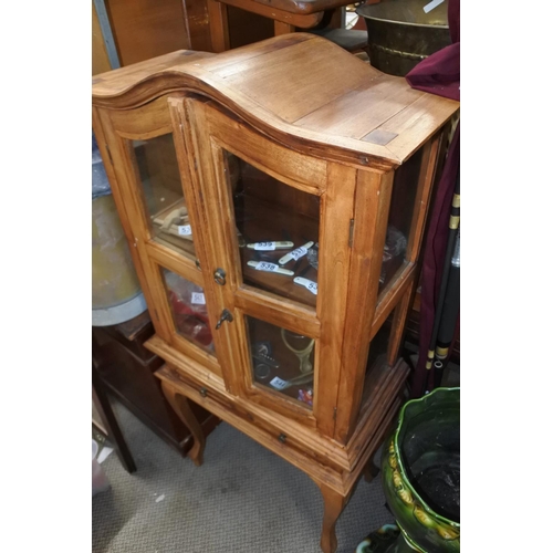 532 - A pine small two door display cabinet with drawer, measuring 60cm x 135cm x 30cm.