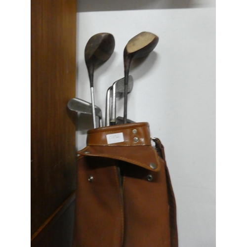 120 - A vintage golf bag and contents.