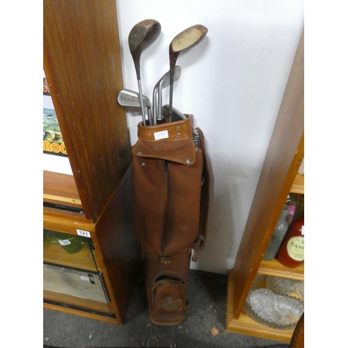 120 - A vintage golf bag and contents.