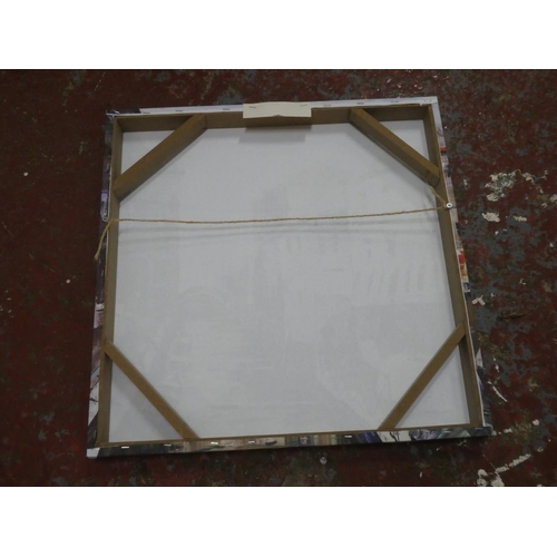 557 - A framed canvas print.