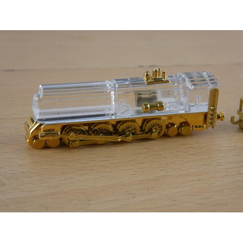 571 - Two miniature brass and glass trains.