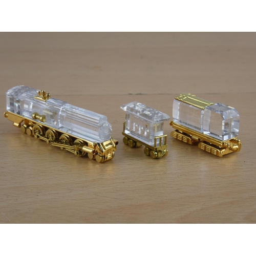 571 - Two miniature brass and glass trains.