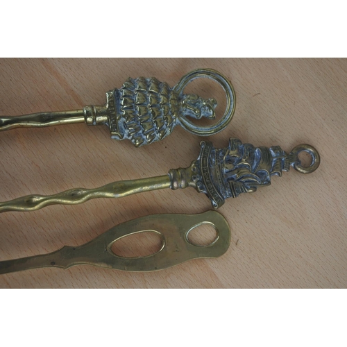 10 - Two vintage brass toasting forks and a spoon.