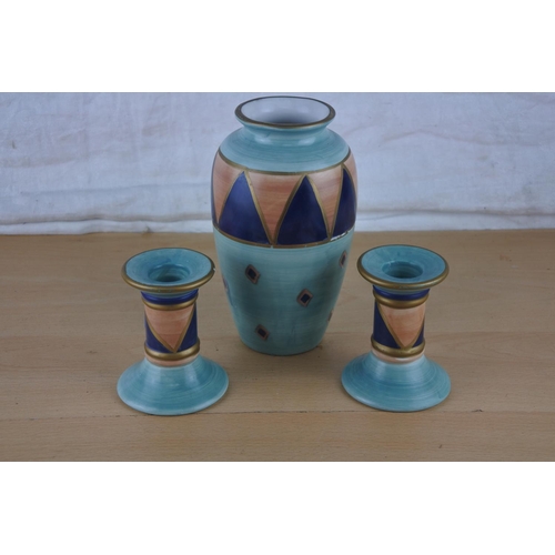 14 - A pair of ceramic candlesticks and matching vase 'Ports of Call' by Jeff Banks, London.