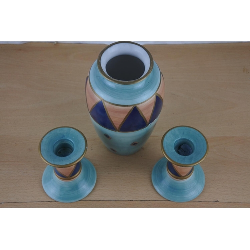 14 - A pair of ceramic candlesticks and matching vase 'Ports of Call' by Jeff Banks, London.