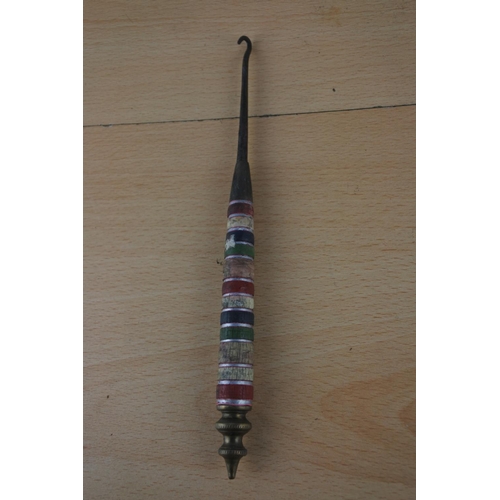 17 - Two ornamental daggers and a decorative button hook.
