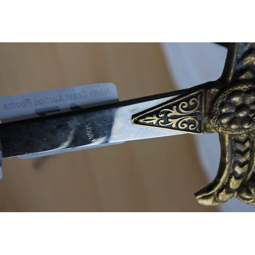 17 - Two ornamental daggers and a decorative button hook.