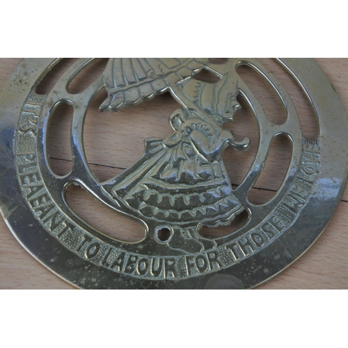19 - A large brass plaque 'It'a Pleaeant to Labour for those we Love' and another.