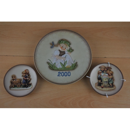 21 - A large Hummel '2000' collectors plate and two small Hummel plates 'Rock-a-Bye' and 'Pleasant Journe... 