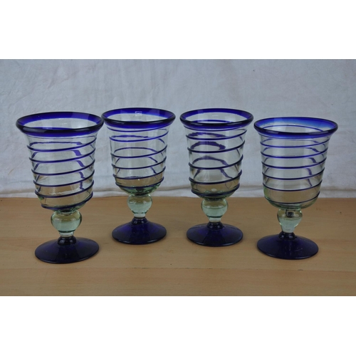 22 - Four large blue glass hand blown goblets.