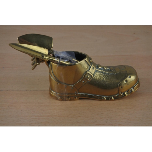24 - A brass boot and three novelty brass gardening tools.