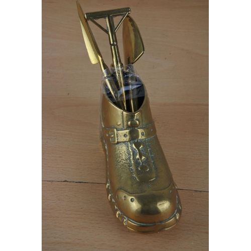 24 - A brass boot and three novelty brass gardening tools.