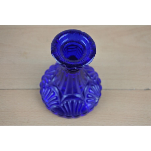 34 - A Victorian blue glass candlestick.