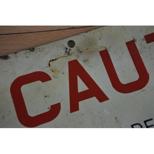 39 - A metal 'Caution' sign. Approx 10x23cm.