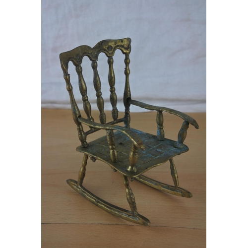 50 - An ornamental brass rocking chair.