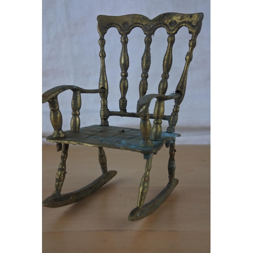 50 - An ornamental brass rocking chair.