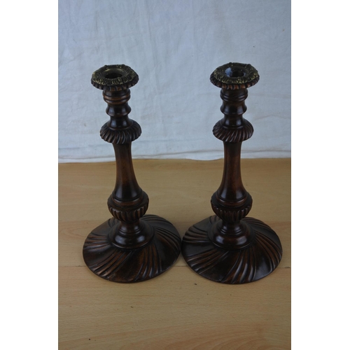 55 - A pair of wood turned candlesticks. Approx 30cm.