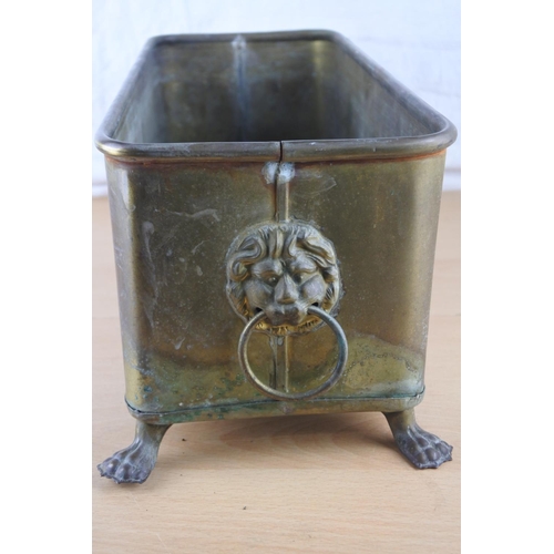 57 - A brass trough planter with lion mask handles. Approx 15x39cm.