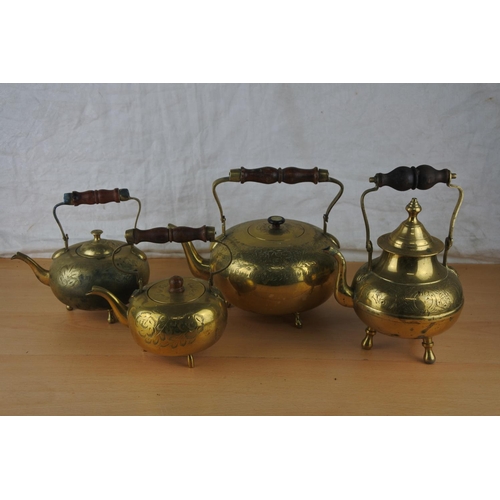 67 - Four vintage brass teapots.