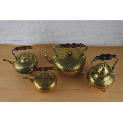 67 - Four vintage brass teapots.