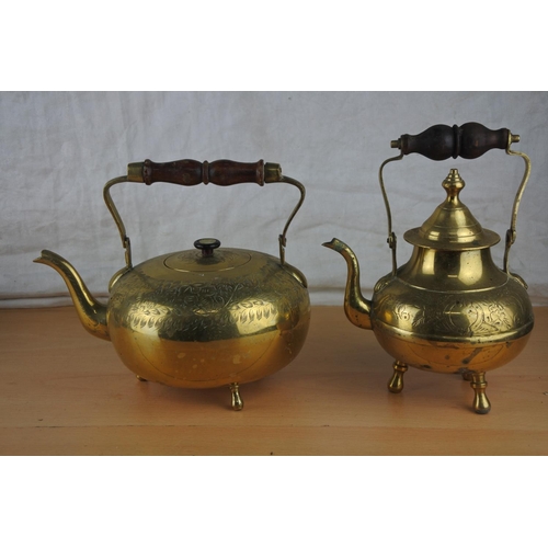 67 - Four vintage brass teapots.