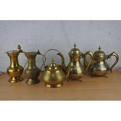 96 - A lot of brass jugs and teapots.