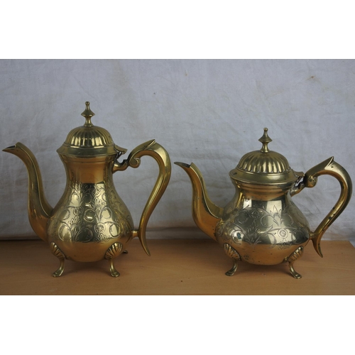 96 - A lot of brass jugs and teapots.