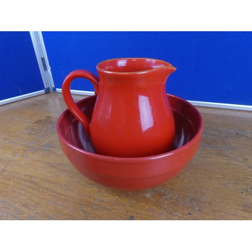 122 - A pottery jug and similar style bowl.