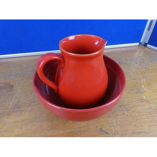 122 - A pottery jug and similar style bowl.