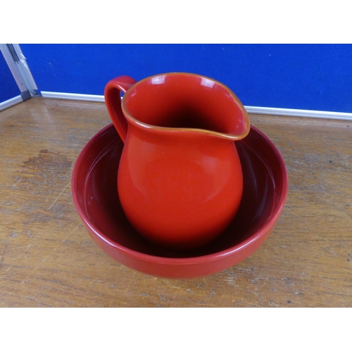 122 - A pottery jug and similar style bowl.