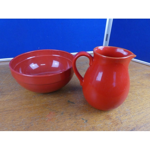 122 - A pottery jug and similar style bowl.