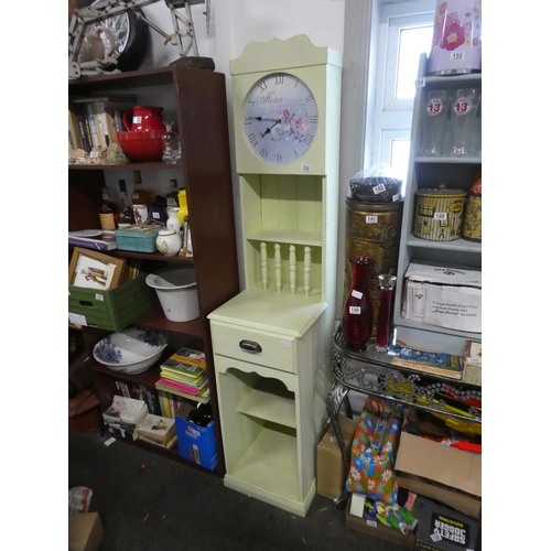 128 - An unusual slimline painted display unit with clock. Approx 187cm.