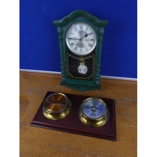 132 - A wall mounted barometer and a wall clock.