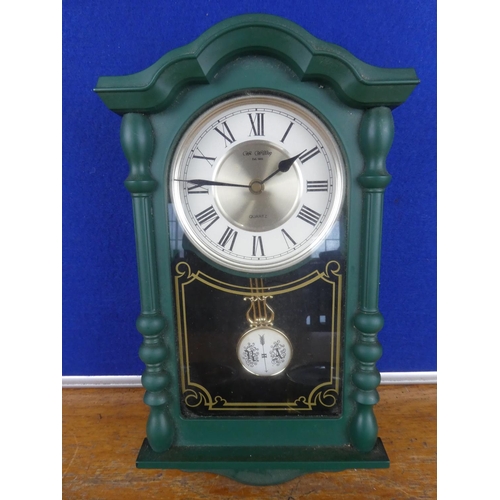 132 - A wall mounted barometer and a wall clock.