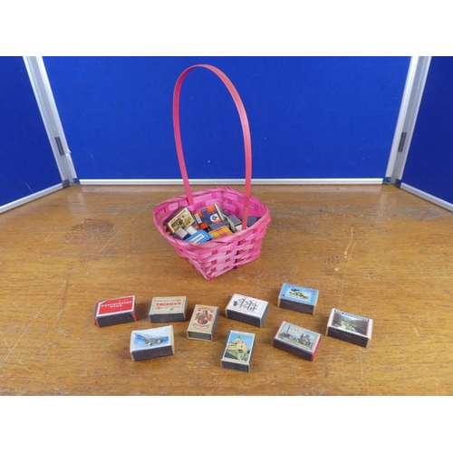 137 - A collection of vintage cigarette boxes in a wicker basket.