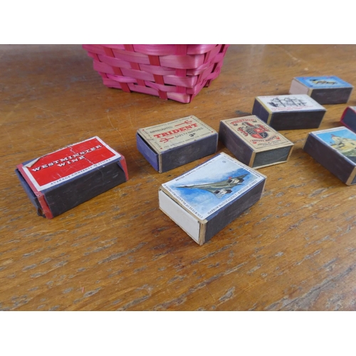 137 - A collection of vintage cigarette boxes in a wicker basket.