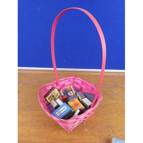 137 - A collection of vintage cigarette boxes in a wicker basket.