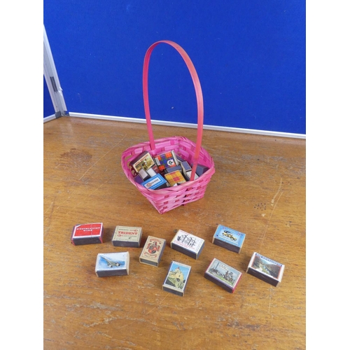 137 - A collection of vintage cigarette boxes in a wicker basket.