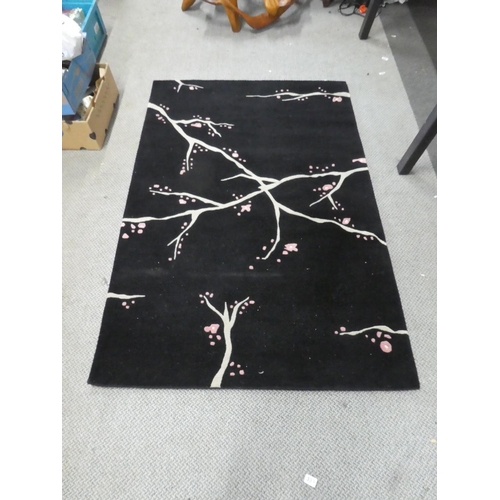 158 - A patterned floor rug. Approx 183x121cm