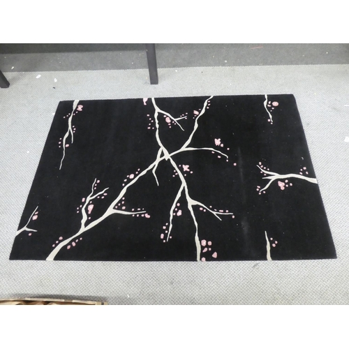 158 - A patterned floor rug. Approx 183x121cm