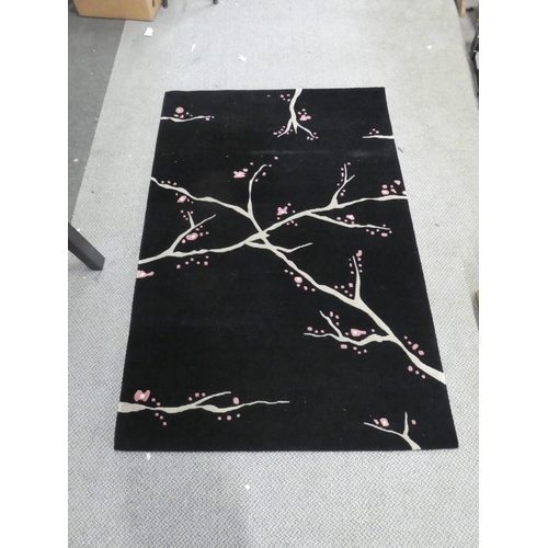 158 - A patterned floor rug. Approx 183x121cm