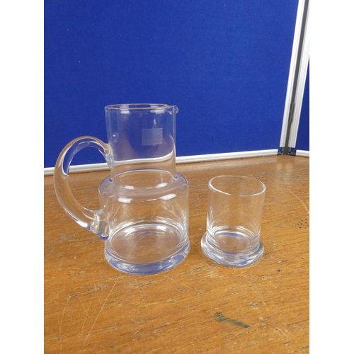 199 - A glass jug and tumbler set.