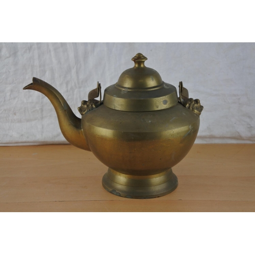 205 - A large brass teapot.