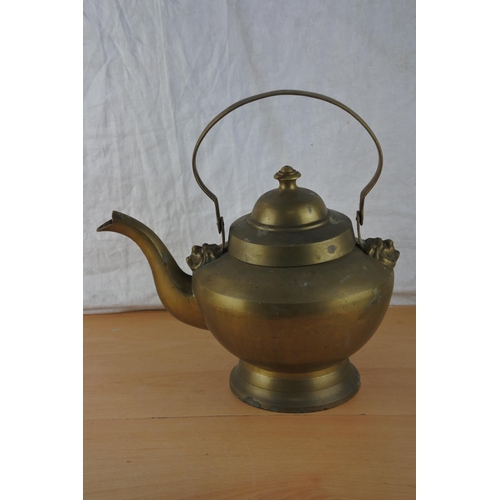 205 - A large brass teapot.