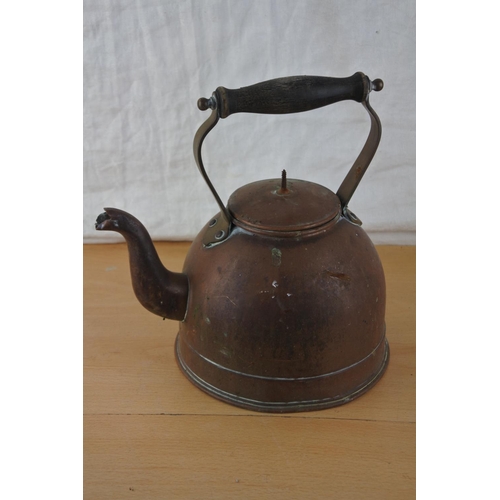 206 - An antique copper kettle.