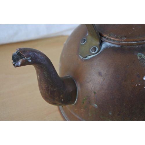 206 - An antique copper kettle.