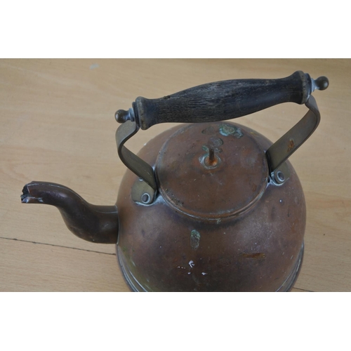 206 - An antique copper kettle.