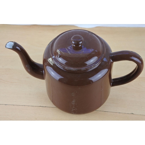 216 - A vintage brown enamel teapot.